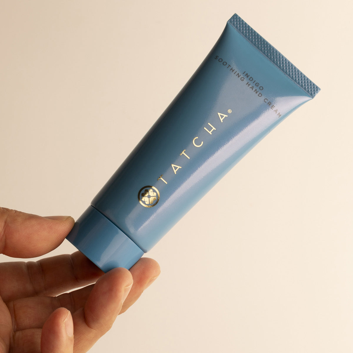 Model holding Indigo Hand Cream