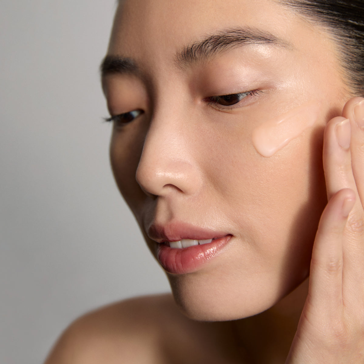Model application showcasing the Tatcha Longevity Memory Cream
