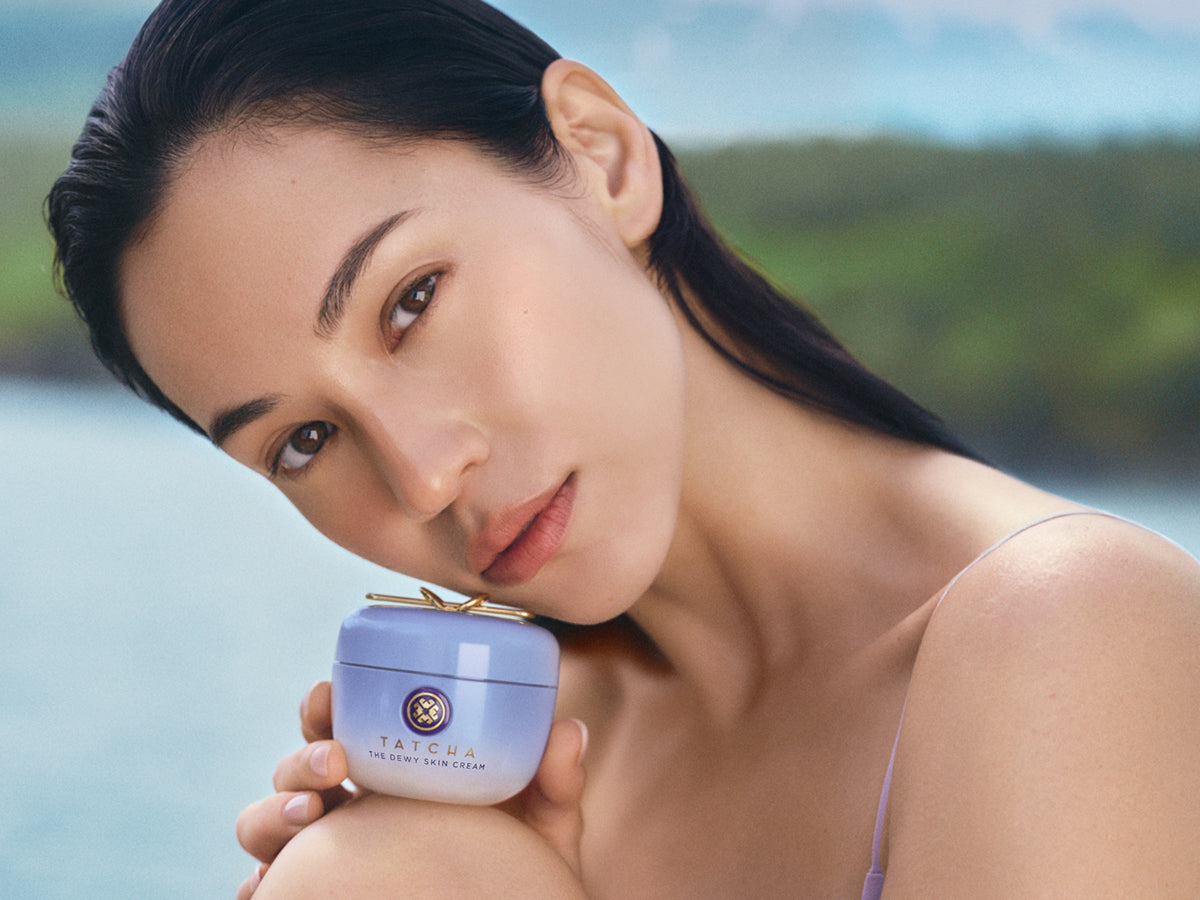 Model holding The Dewy Skin Cream