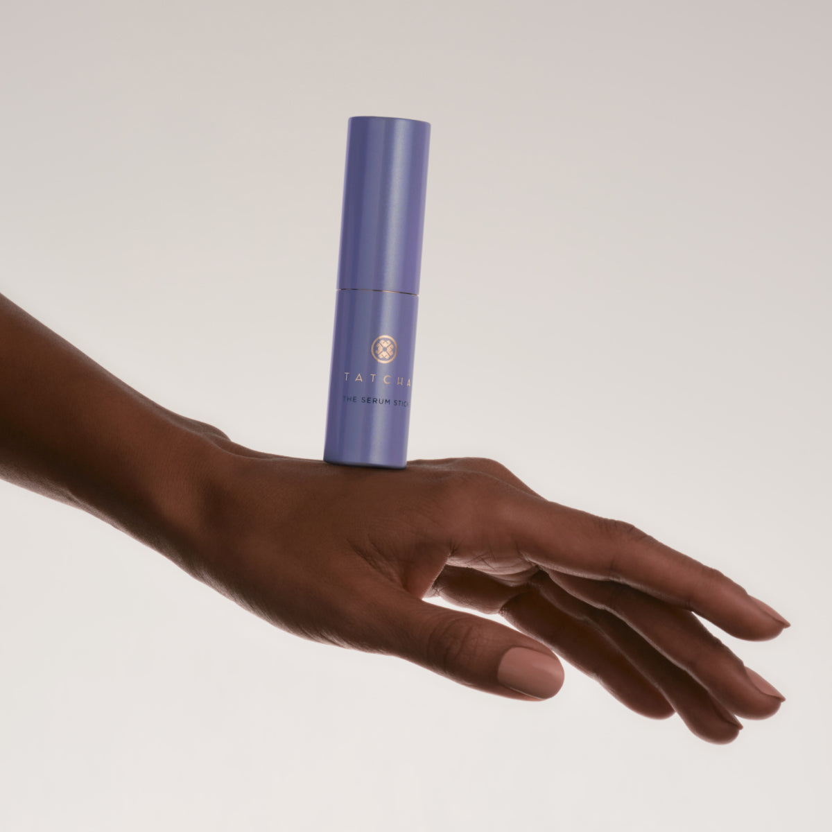 Hand balancing the Tatcha Serum Stick