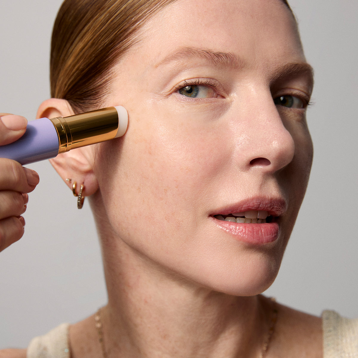 Model application showcasing the Tatcha Serum Stick