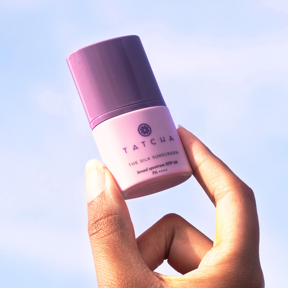 Model holding The Silk Sunscreen SPF 50 mini