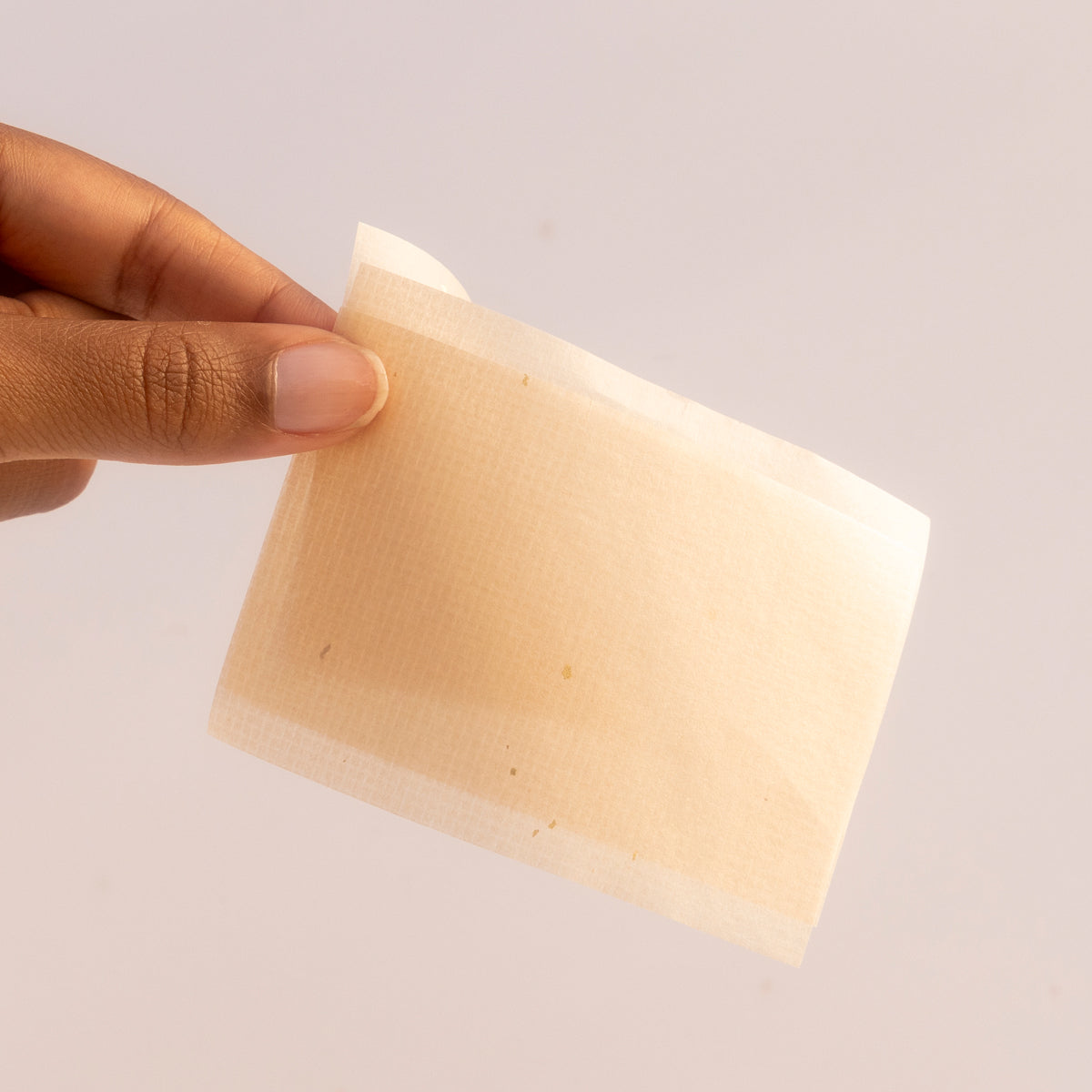 Hand Holding Aburatorigami blotting paper