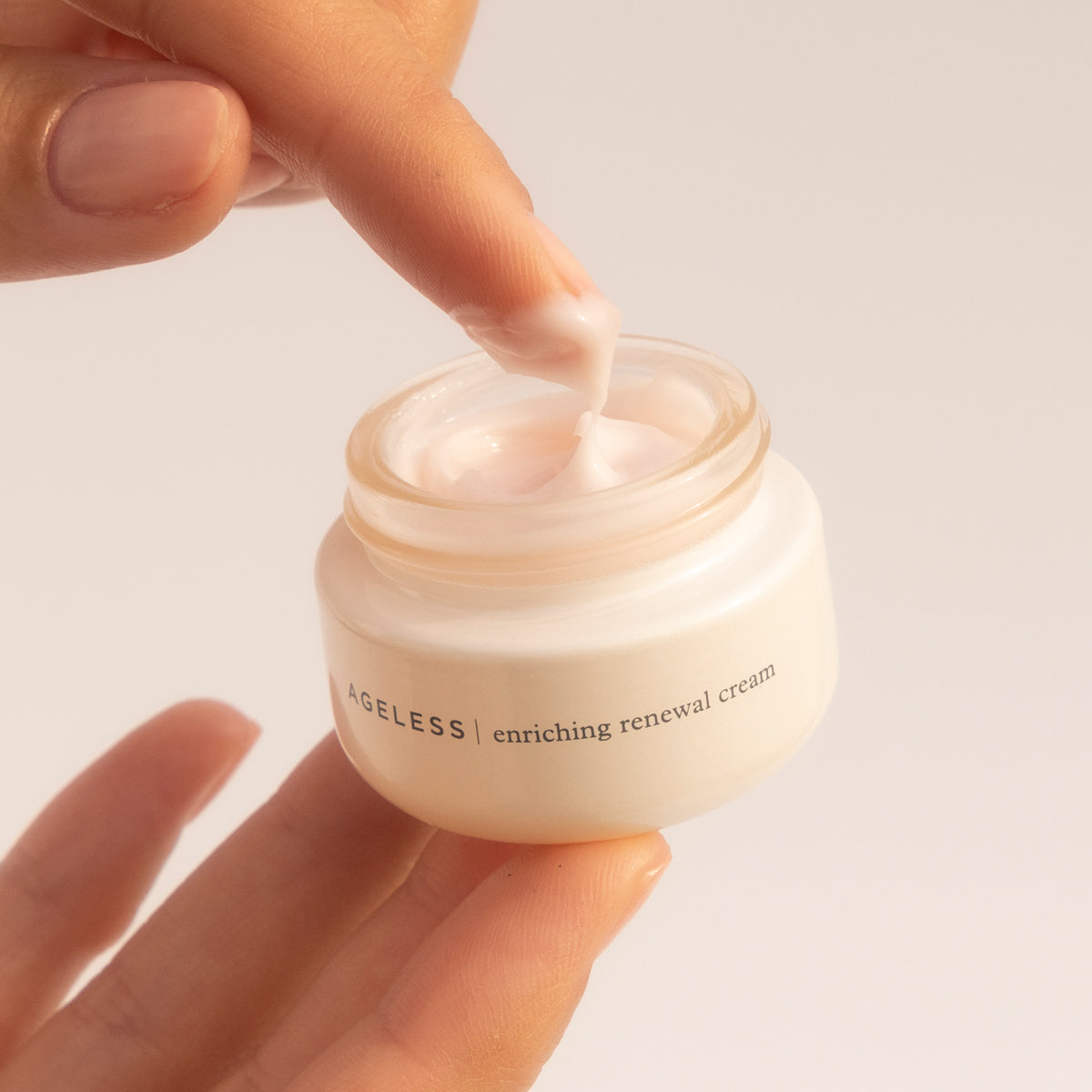 Finger dipping into Ageless Enriching Renewal Cream 