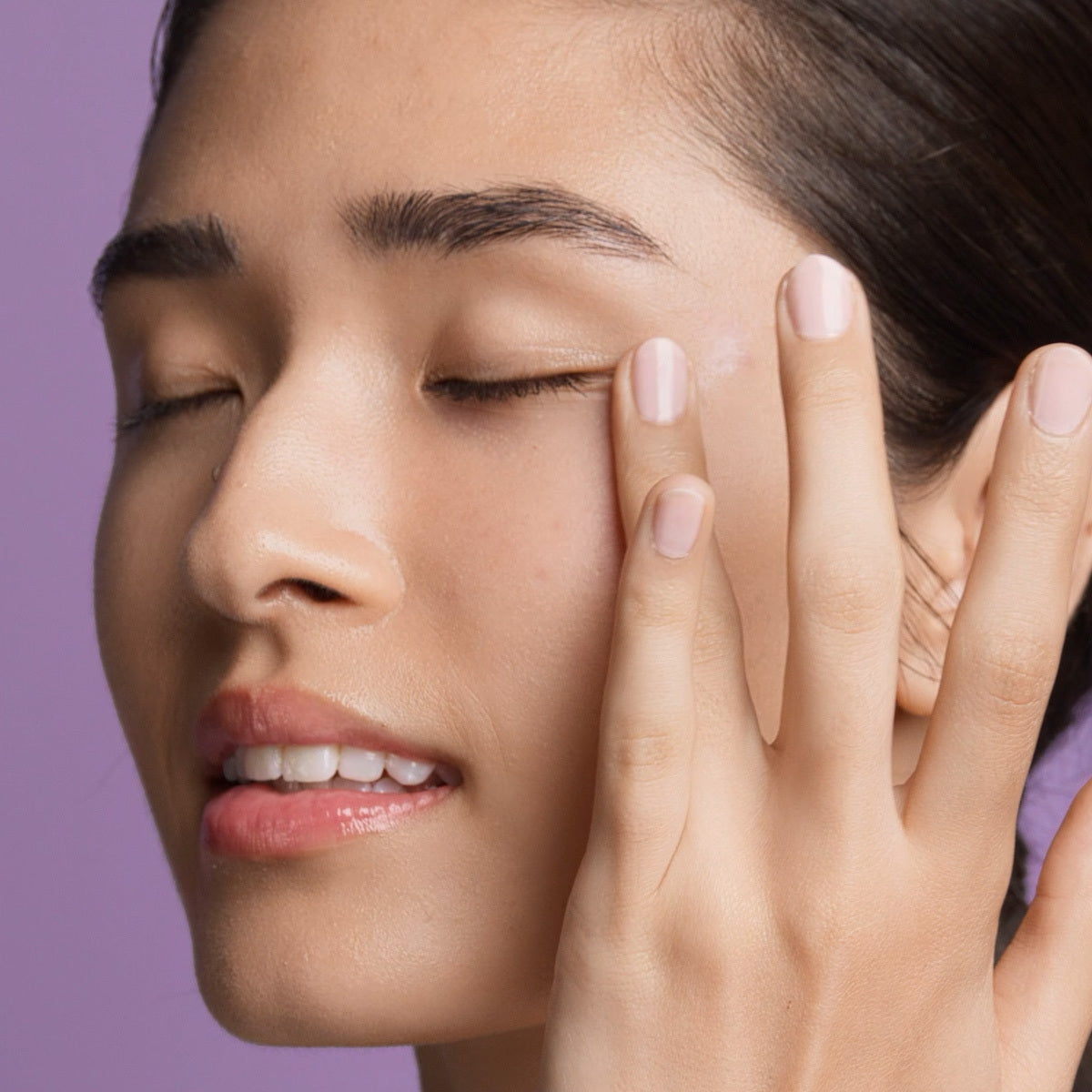 Model applying Ageless Revitalizing Eye Cream.