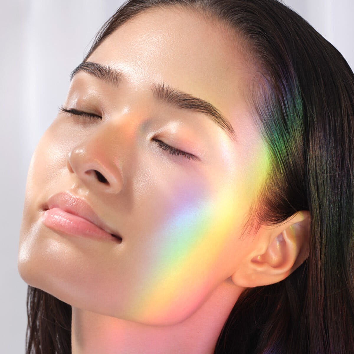 Woman with clear skin and prism across face