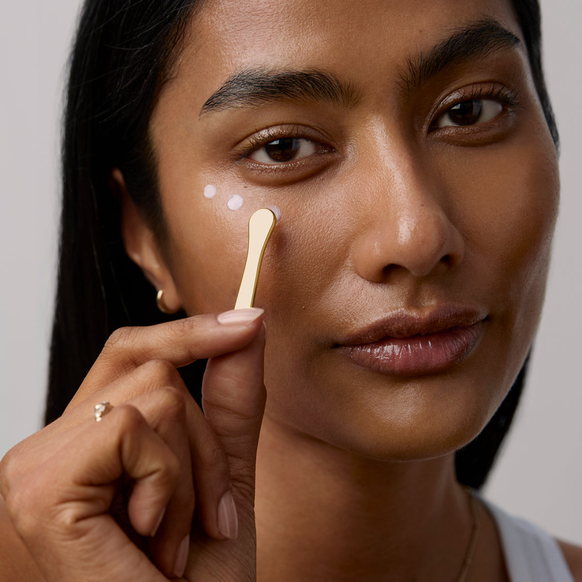 Model application showcasing the Tatcha Brightening Eye Cream