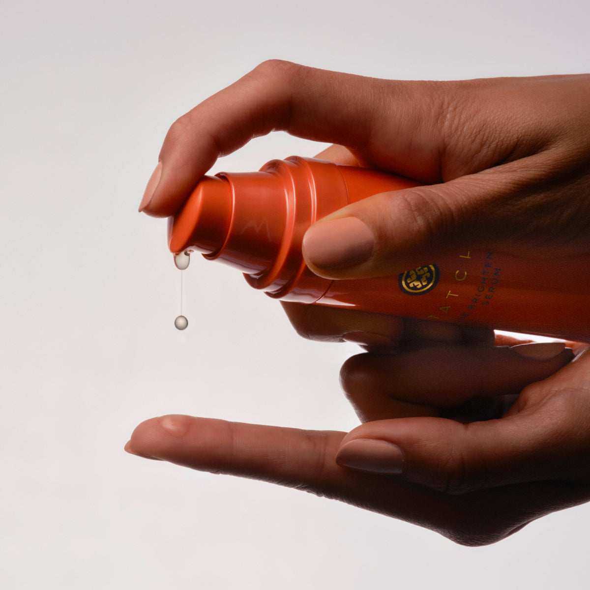 Hands pumping out the Tatcha Brightening Serum