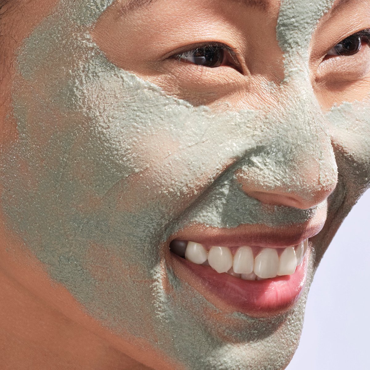 Shot of model with The Clarifying Clay Mask applied to face.