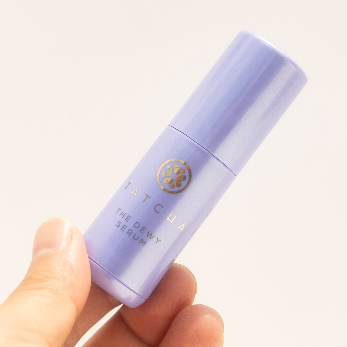 hand holding the mini Dewy Serum