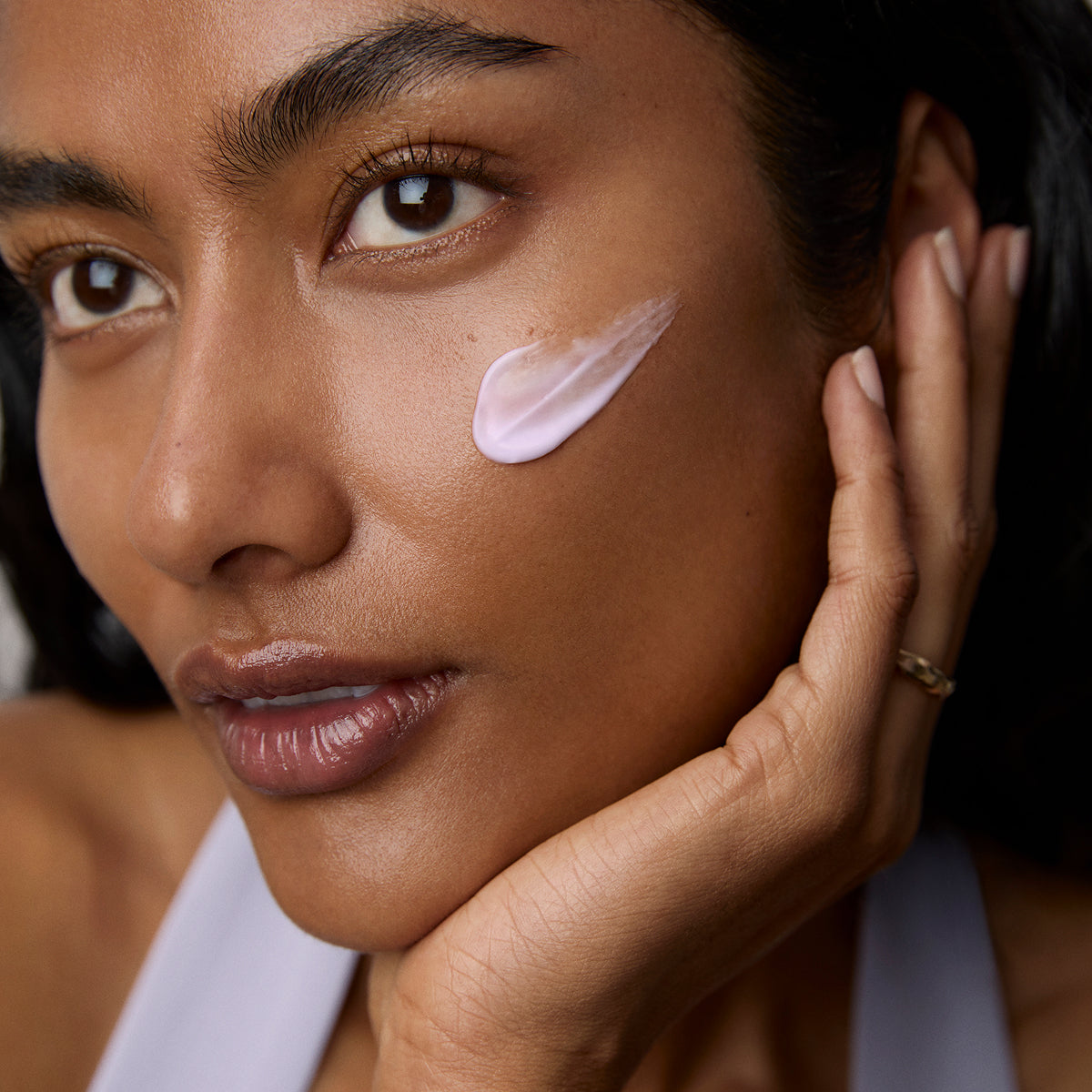 Model application showcasing the Tatcha Dewy Skin Cream