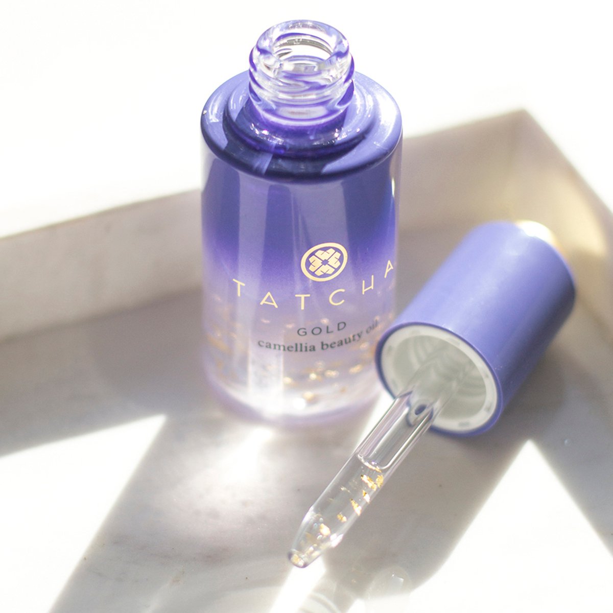 Gold Camellia Beauty Oil with applicator top showing.