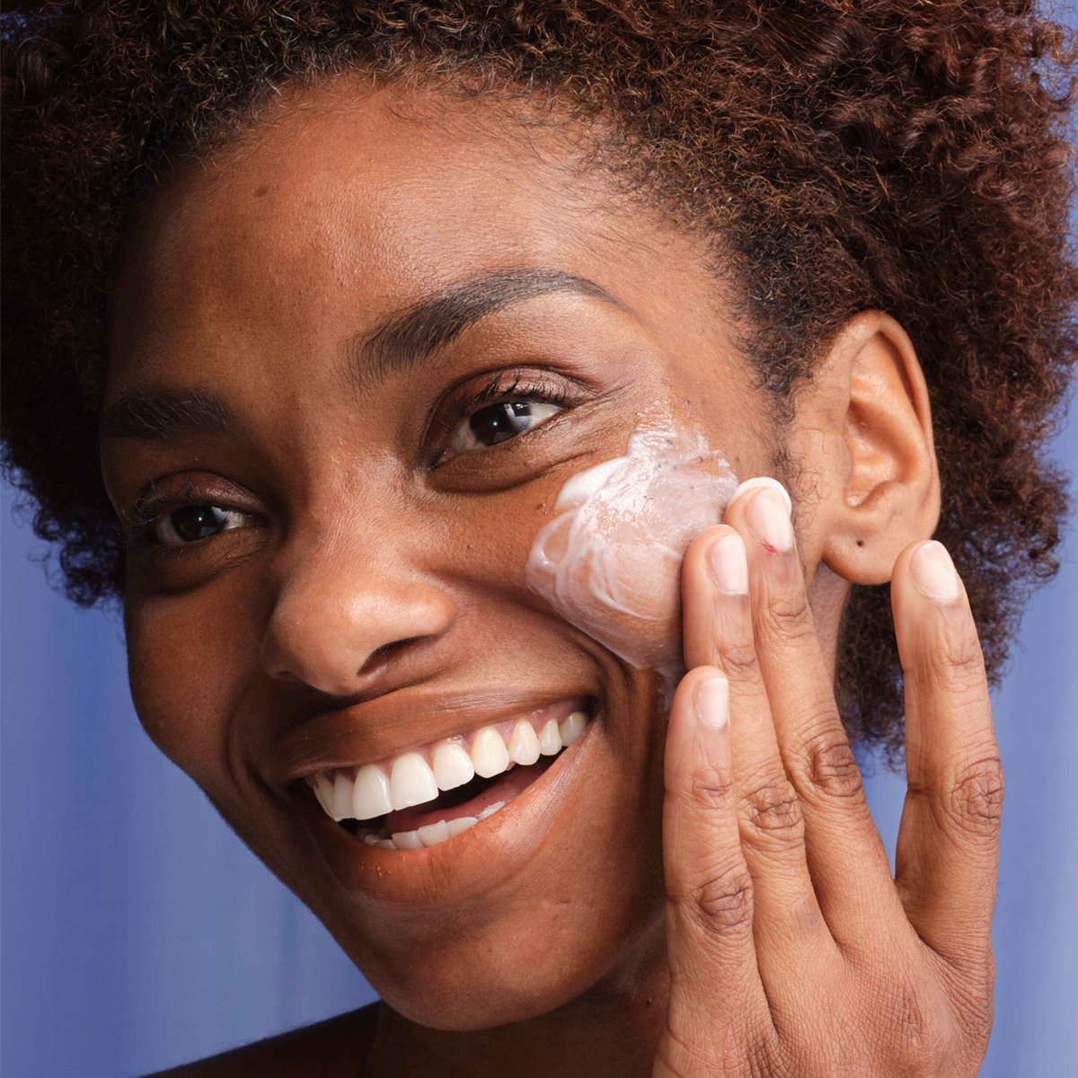 Woman applying Indigo Overnight Repair to her face