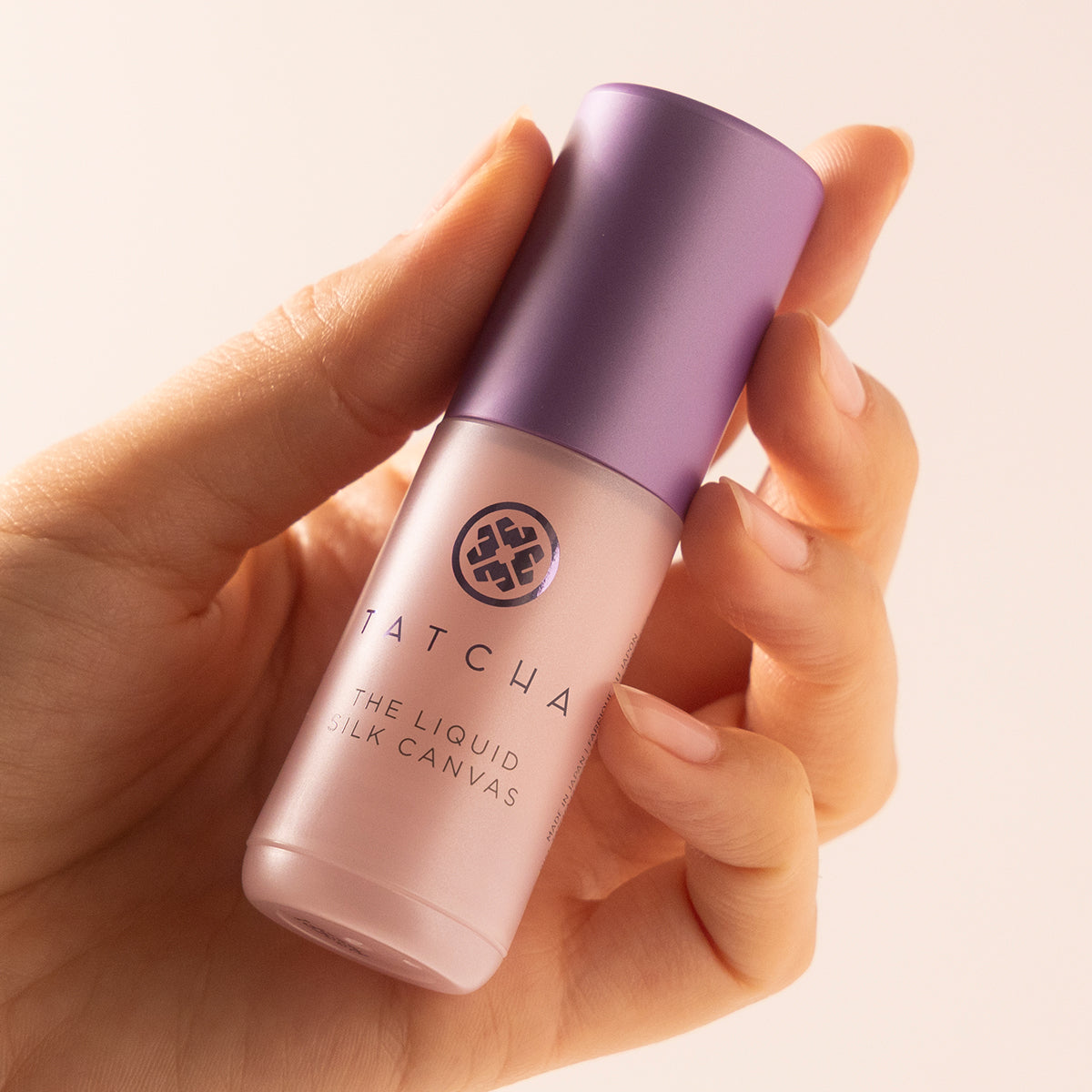 Hand holding mini liquid silk canvas foundation 