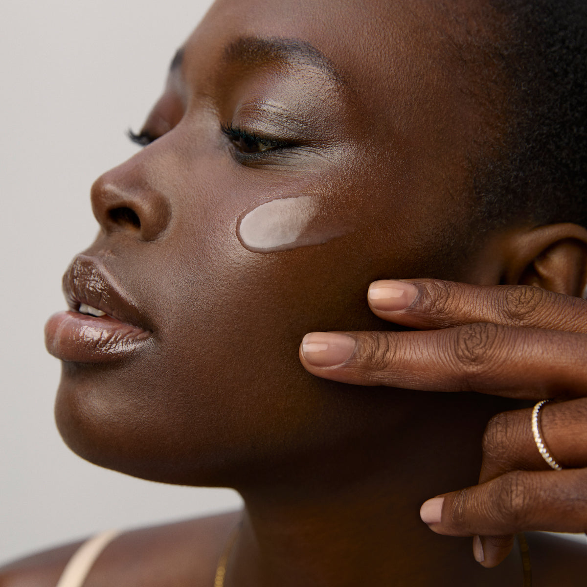 Model application showcasing the Tatcha Longevity Serum