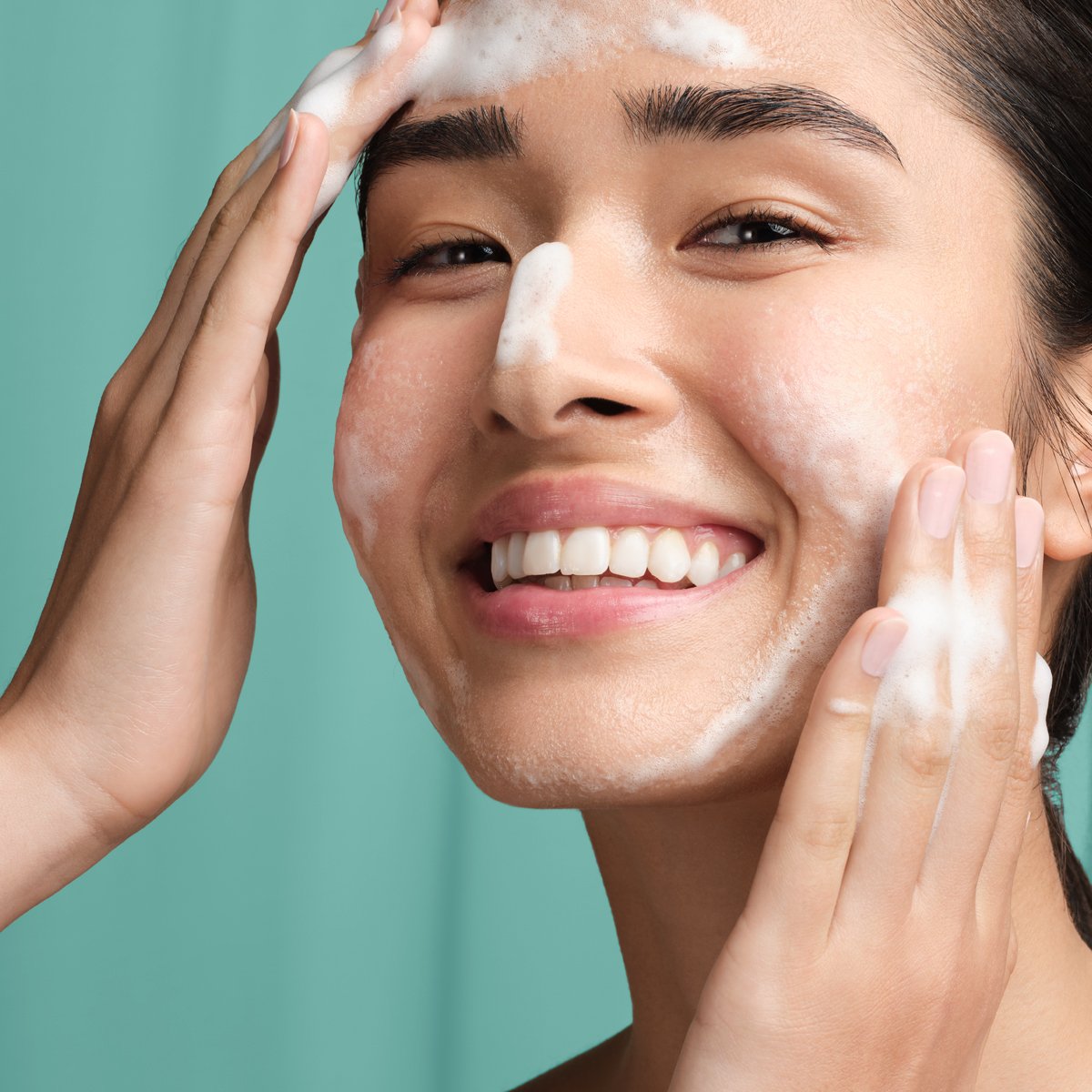 Woman washing face with The Matcha Cleanse