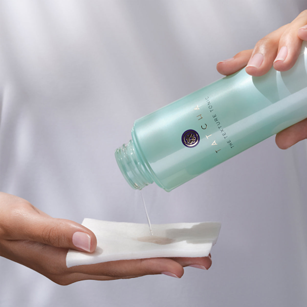 The Texture Tonic being poured onto our Organic Cotton Pads for application.