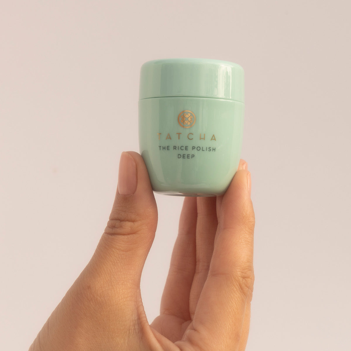 Hand holding the Rice Polish Deep, mini