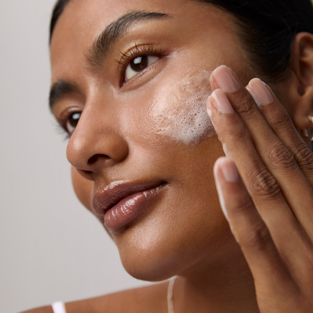 Model application showcasing the Tatcha Rice Wash
