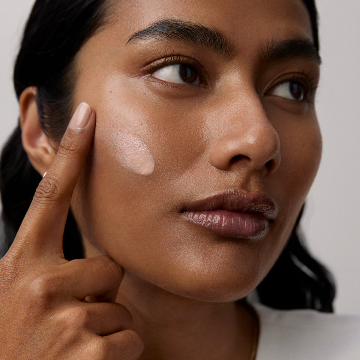Model application showcasing the Tatcha Silk Sunscreen