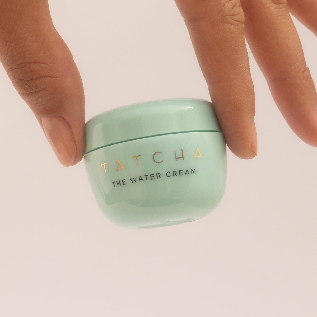 Hand holding Water Cream Mini