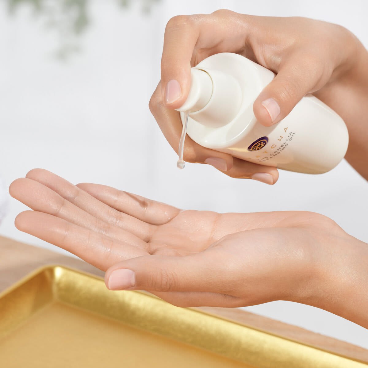 Pumping The Camellia Cleansing Oil into hand