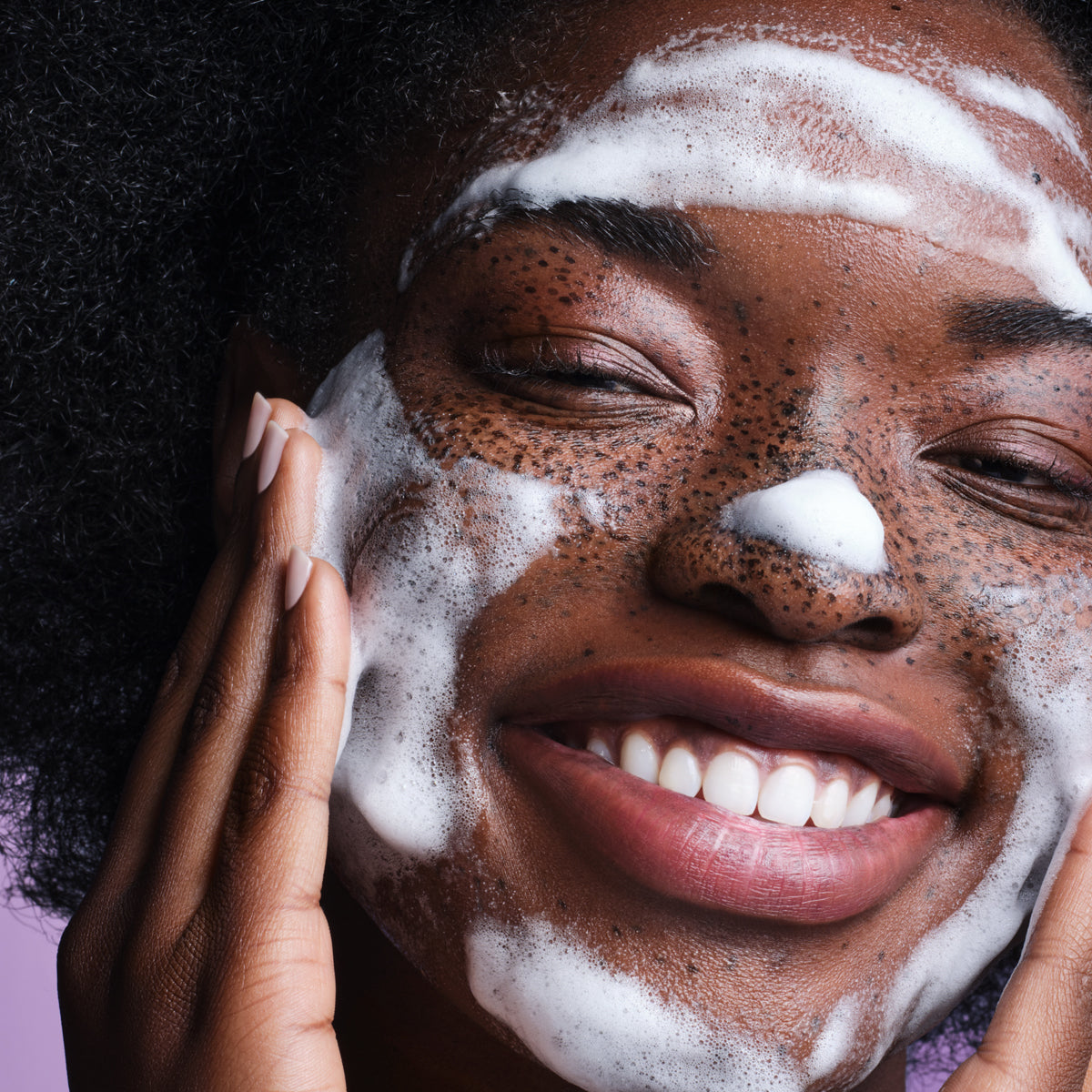 Woman washing face with The Rice Wash